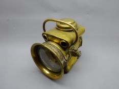 Powell & Hamner brass acetylene Motor Headlamp, the pierced shaped body with two side brackets,