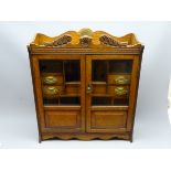 Large early 20th century oak smokers cabinet with two, part glazed panel doors and fitted interior,