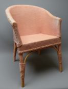 Early 20th century child's pink basketwork armchair,