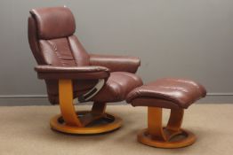 Swivel reclining armchair upholstered in brown leather with matching footstool Condition