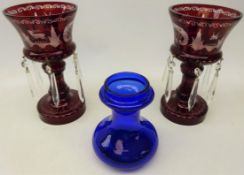 Pair Bohemian ruby glass lustres etched with stags amongst scrolls with faceted glass drops,