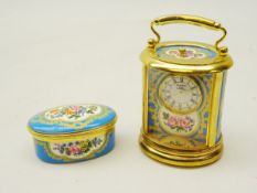 Halcyon Days miniature carriage clock of oval form with cartouche panels decorated with flowers,