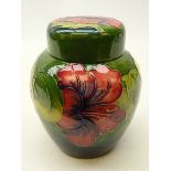 Moorcroft Hibiscus pattern ginger jar and cover on green ground,