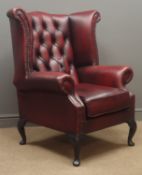 Georgian style wingback armchair, upholstered in ox blood red deeply buttoned leather,