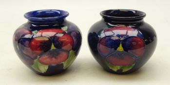 Two Moorcroft Pansy pattern baluster vases on blue ground,