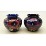 Two Moorcroft Pansy pattern baluster vases on blue ground,