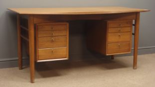 Mid 20th century teak desk, two banks of four graduating drawers, turned tapering supports, W160cm,