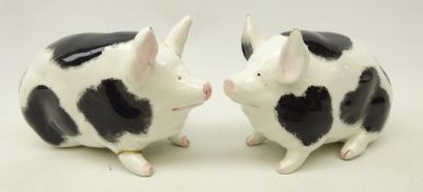 Two Wemyss pottery pig models in black and white,