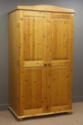 Pine double wardrobe, shaped pediment, two doors enclosing fitted interior, turned bun feet, W104cm,