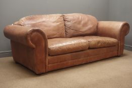 Two seat sofa upholstered in brown leather,