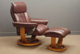 Swivel reclining armchair upholstered in brown leather with matching footstool Condition
