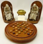 Early 20th century solitaire board on three feet complete with clay marbles,