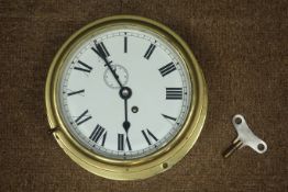 20th century circular brass cased ship's bulk head clock, single train driven movement,