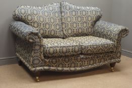 Pair two seat traditional style sofas with mahogany feet on brass castors,