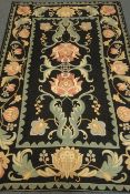 Kashmiri hand stitch wool rug, black ground, floral pattern, repeating border,