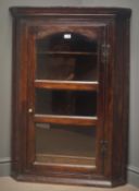 George III mahogany wall hanging corner cabinet, projecting cornice,