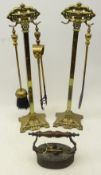 Pair Art Nouveau brass Companion sets with lozenge moulded terminal on shaped pierced base,
