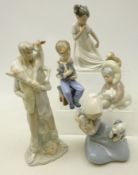 Three Lladro figures; Eskimo boy with Polar Bear, Girl with dog and cat,