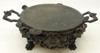 19th century cast metal plate warmer, cast with figural masks,