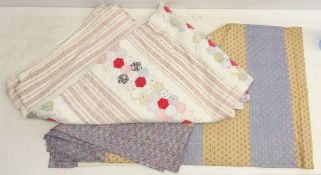 Two patchwork quilts, decorated with floral and other patterns,