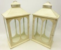 Pair cream painted glazed lanterns with carry handles,