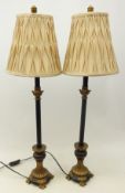 Pair ebonised table lamps on gilt reeded flared base and scroll feet,