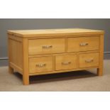 Light oak coffee table chest with half hinged top, three short and two long drawers, stile supports,