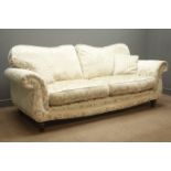 Three seat sofa upholstered in gold fabric with floral pattern, turned supports,