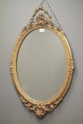 19th century oval mirror, gesso frame with ribbon tied cresting, W58cm,
