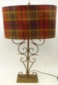 Large gilt metal table lamp with scroll stem and tartan shade,
