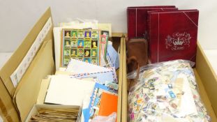 Large quantity of World stamps, in albums, on album pages, on and off paper etc,