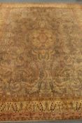 Large Persian design carpet, field decorated with swirled foliage, central medallion,