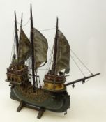 Painted wooden model of a three mast Galleon on stand,
