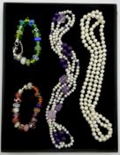 Two pearl and amethyst necklaces and two glass beaded bracelets,