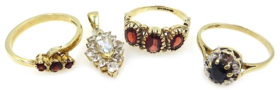 Two three stone garnet gold rings,