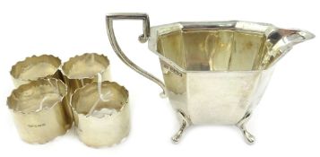 Set of four plain silver napkin rings Birmingham 1930 and a cream jug by Viner's Ltd Sheffield 1933,