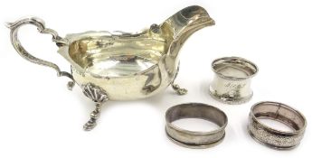 Silver sauce boat Birmingham 1906 and three hallmarked silver napkin rings approx 6.