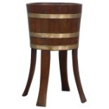 Edwardian coopered teak jardiniere, copper bound circular body on four outsplayed angular supports,