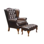 Georgian style wingback armchair and matching stool, upholstered in deeply buttoned brown leather,