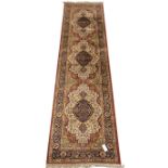 Persian style red ground runner rug, triple floral medallions, scrolled guarded border,