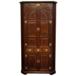 Large George III mahogany corner cupboard, projecting cornice above frieze inlaid with shell motifs,
