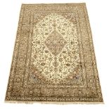 Persian Kashan rug, ivory ground with trailing foliage design, stylised flower heads,
