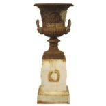 Large cast iron urn, gadrooned top and scroll body with lions mask handles,