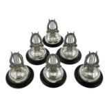 Set of six silver lyre harp menu holders, on ebonised circular bases by Adie & Lovekin Ltd,