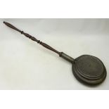 19th century pewter warming pan, pierced cover with wrigglwork stylised trailing foliage,