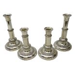 Set of four early 20th century silver-plated telescopic table candlesticks,