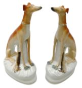 Pair of Victorian Staffordshire seated Greyhounds with dead game,