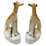 Pair of Victorian Staffordshire seated Greyhounds with dead game,