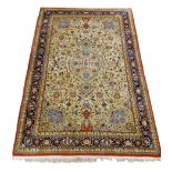 Fine Persian rug, beige field with trailing stylised flower heads and foliage,