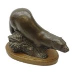 Bronze model of an Otter on a rocky base by Michael Rizzello, signed 'Rizello 2', on oval oak base,